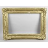 A late 19th century carved and moulded gilt picture frame of rectangular shaped form with leaf and