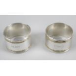 A pair of bi-colour napkin rings by Tiffany & Co, each with name engravings and reeded edge.