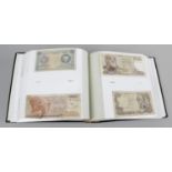 An album containing a small mixed selection of assorted banknotes,