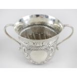 An Edwardian silver cup of cylindrical form with flared rim and twin curved handles,