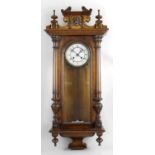 A late 19th century stained wooden cased Vienna style wall clock,