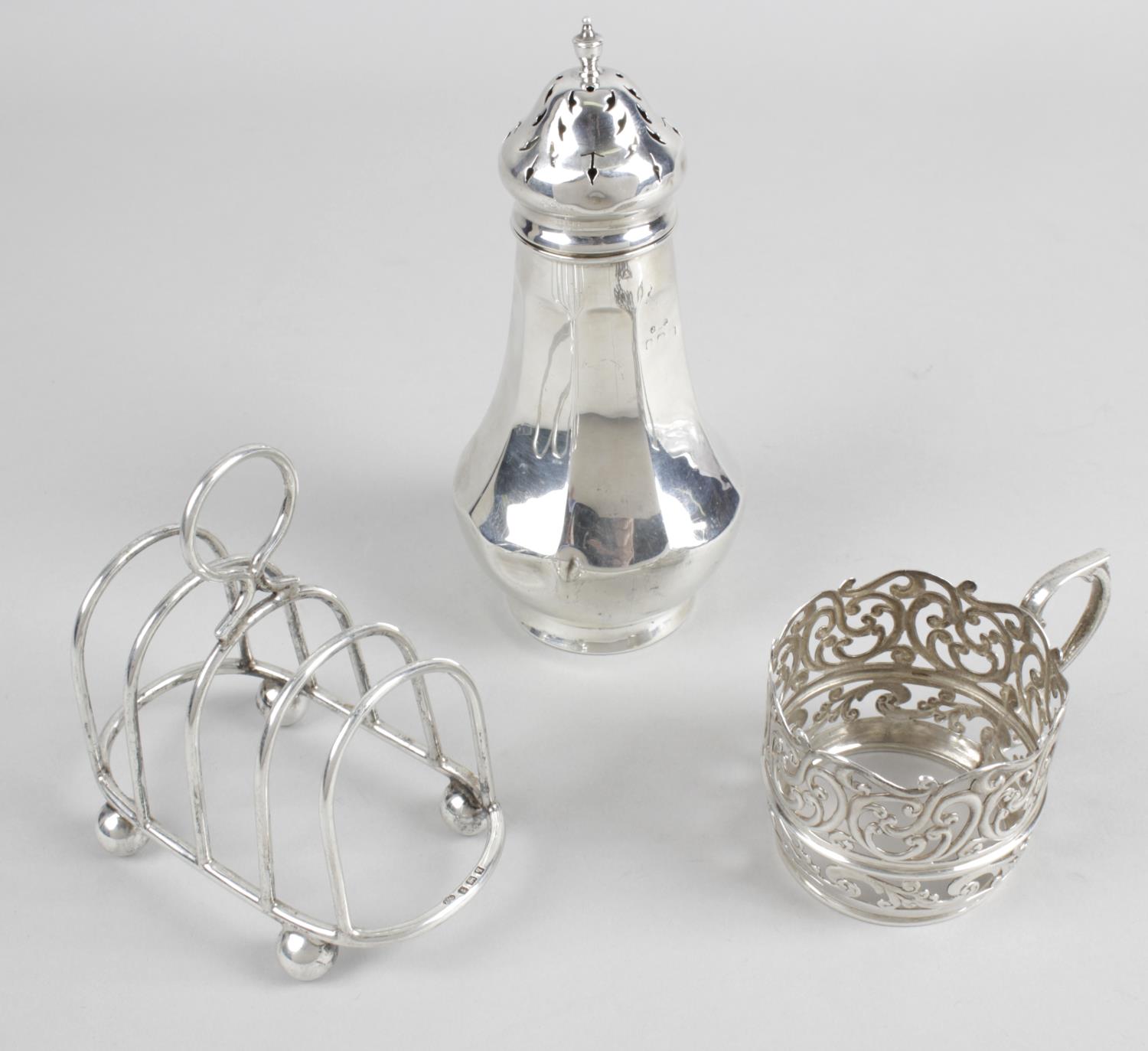 A late Victorian silver cup holder with foliate scroll pierced decoration to the whole and beaded