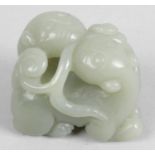 A Chinese carved nephrite jade study, modelled as two entwined lions, 1.5 (4cm) wide.