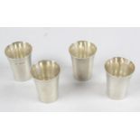 A set of four 1930's silver shot cups, of plain flared cylindrical form.