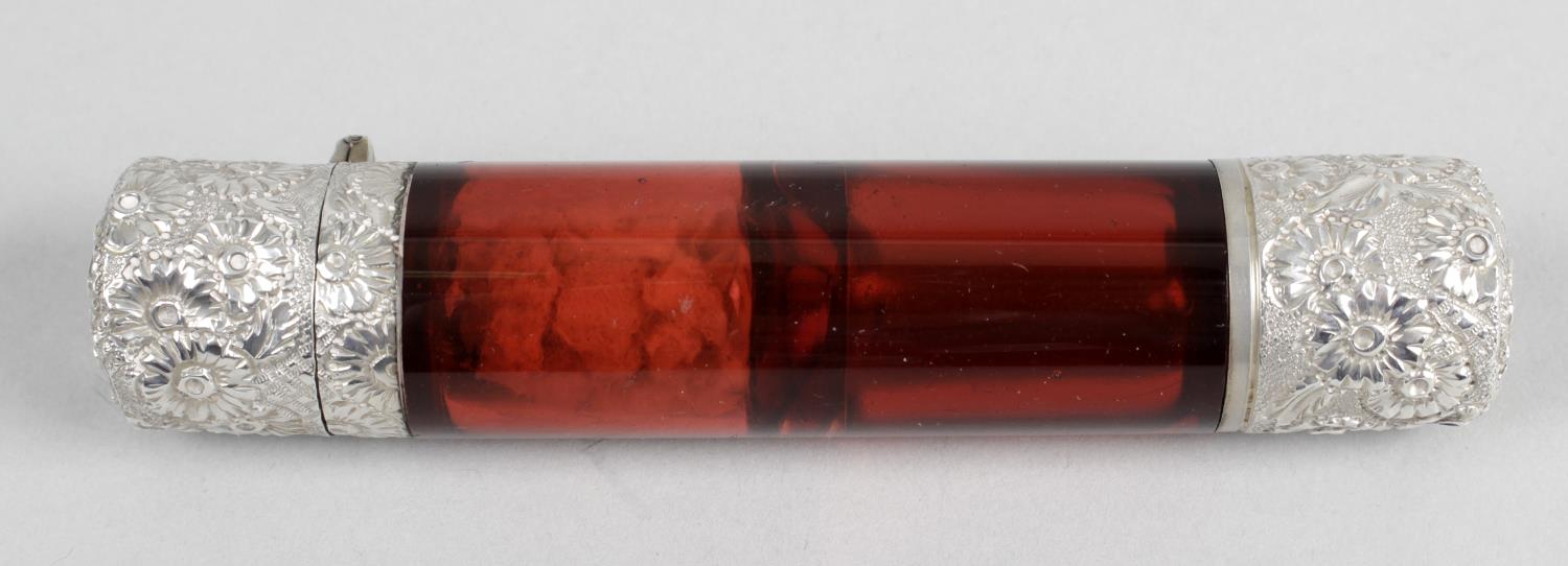 A ruby glass double-ended scent bottle of cylindrical form,