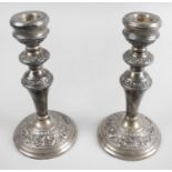 A pair of mid-twentieth century silver mounted candlesticks,