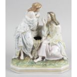 A 19th century porcelain figure group modelled as figures seated at a well, 8 (20.25cm) high.