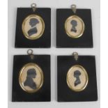 A group of four 19th century individual framed oval head and shoulder silhouettes,