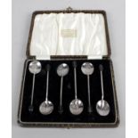A cased set of six 1920's silver coffee spoons with coffee bean terminals,