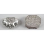 A small box of shaped form with engraved scroll detail to body and hinged lid decorated with