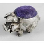 A miniature silver mounted pin cushion, modelled in the form of a pig standing on all fours.