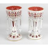 A near pair of cranberry glass lustre vases,