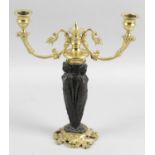 A late 19th century bronze and gilt bronze twin branch candle holder,