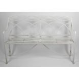 A Regency wrought iron garden bench of reeded strap design,