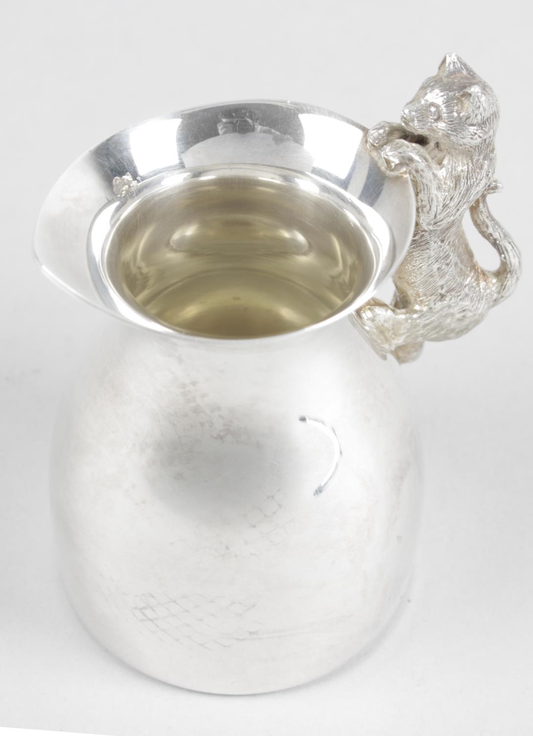 A modern plain silver cream jug,