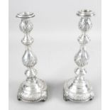 A pair of early George V silver candlesticks,