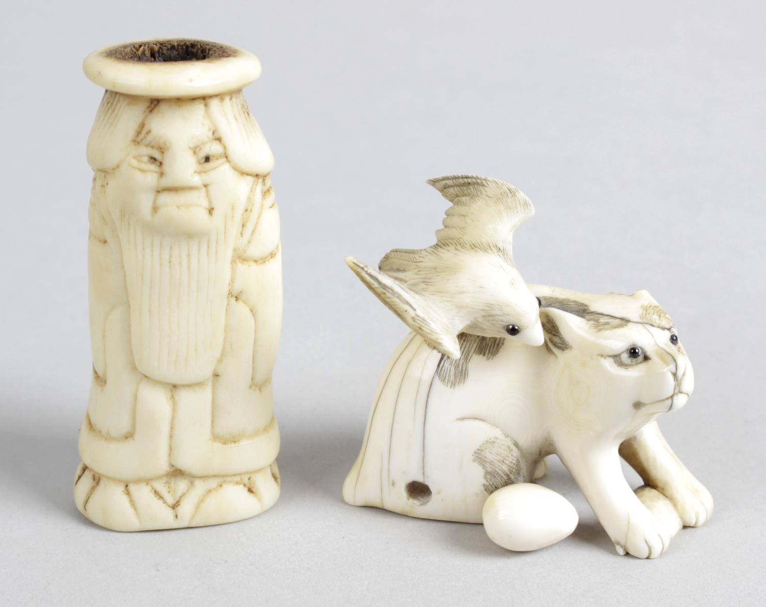 A 19th century ivory netsuke modelled as cat with inset glass eyes,