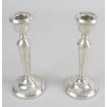 A pair of modern silver mounted candlesticks,