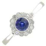 A platinum synthetic sapphire and diamond cluster ring.Estimated total diamond weight