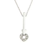 An 18ct gold diamond heart and arrow pendant, suspended from a chain.