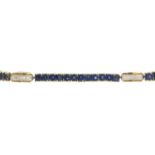 A sapphire and diamond bracelet.Estimated total diamond weight under 0.10ct.Marked 585.Length