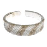 A diamond and 'coloured' diamond bangle.Estimated total diamond weight 17.50 to 18cts.Stamped