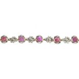 A ruby and diamond bracelet.Estimated total diamond weight 0.90ct.Marked 18ct.Length 18cms.