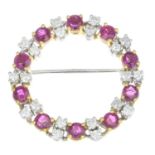 An 18ct gold ruby and diamond wreath brooch.Estimated total diamond weight 0.60ct,
