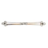 An early 20th century gold diamond bar brooch.Estimated total old-cut diamond weight 0.70ct,