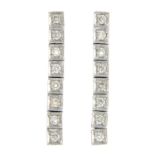 A pair of diamond earrings.Estimated total diamond weight 0.65ct.Length 2.8cms.