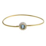 A bangle, with topaz and cubic zirconia cluster.Stamped 750.Italian marks.Inner diameter 5.9cms.