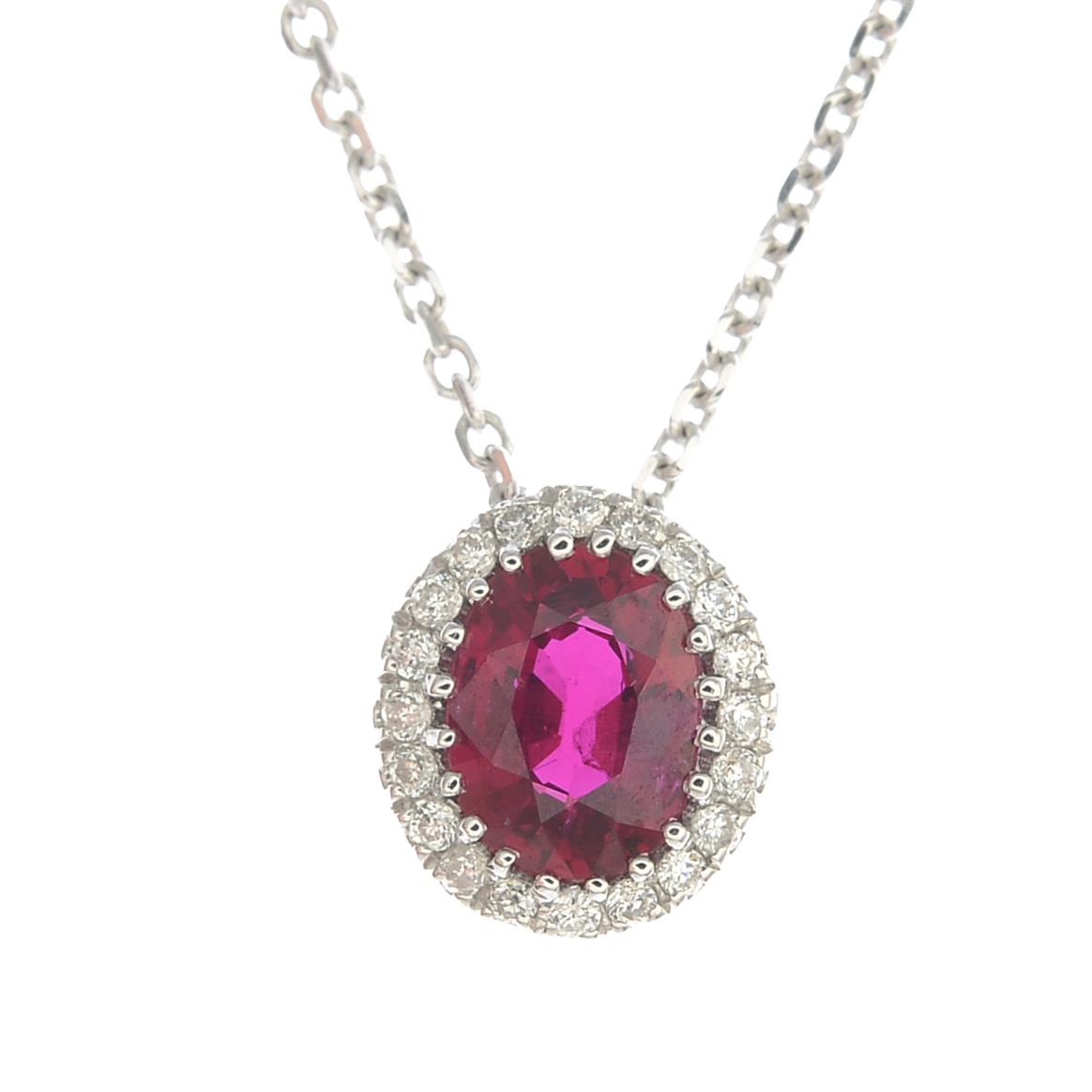 A ruby and diamond cluster pendant, suspended from a chain.Ruby weight 0.36ct.
