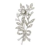 An 18ct gold diamond floral brooch.Estimated total diamond weight 0.90ct,