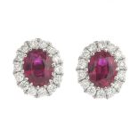 A pair of ruby and diamond cluster earrings.Total ruby weight 0.54ct.