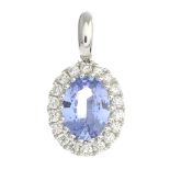 A sapphire and diamond cluster pendant.Sapphire weight 0.71ct,