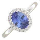 A sapphire and diamond cluster ring.Sapphire weight 0.99ct.