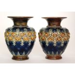 A pair of Royal Doulton stoneware vases of shouldered ovoid form with a flared collar neck,