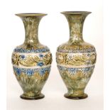 A pair of Doulton Lambeth stoneware vases of shouldered ovoid form with flared collar necks,