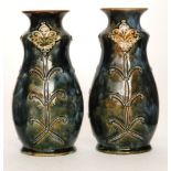 A pair of Royal Doulton stoneware vases of swollen ovoid form with dimple moulded collar necks,