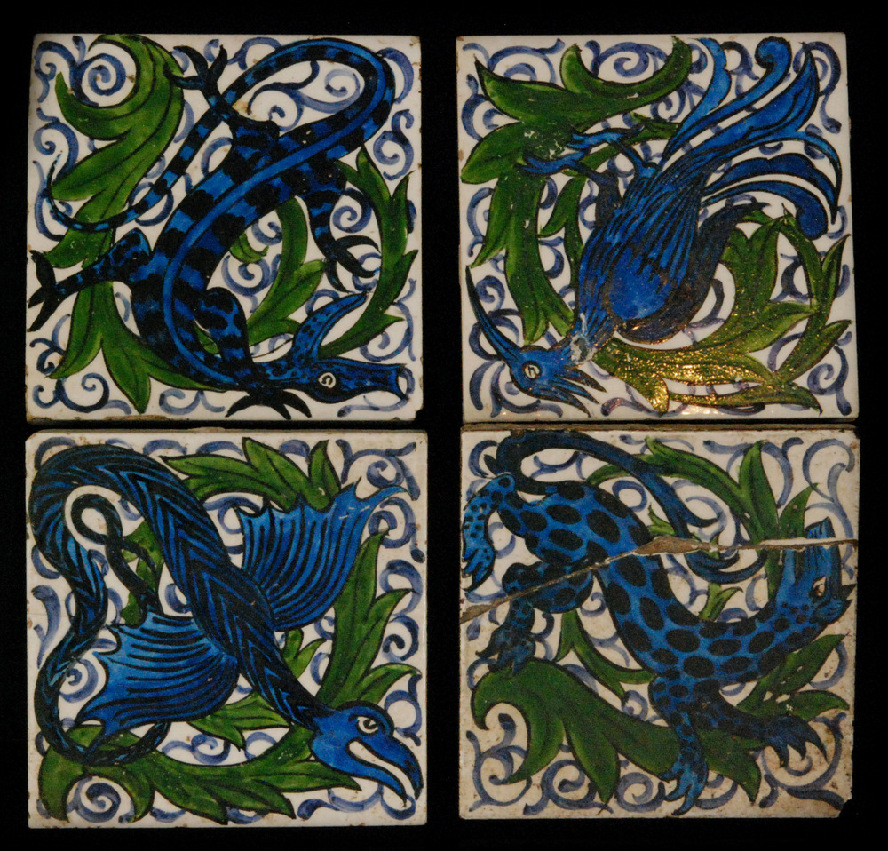A set of four early 20th Century 4 inch dust pressed tiles decorated with a design in the manner of