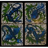 A set of four early 20th Century 4 inch dust pressed tiles decorated with a design in the manner of