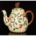 An early 20th Century Minton Aesthetic teapot of gourd form with relief moulded leaves and branches