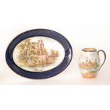 A Royal Worcester oval dish decorated with a hand tinted scene of Warwick Castle within a blue