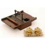A 19th Century rosewood travelling desk box fitted with an ink well and a brass inkstand (2)