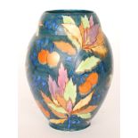 A large 1930s Carlton Ware Art Deco Handcraft vase decorated in the Cherry pattern with leaves and