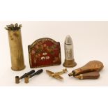 A small copper hunting horn, two copper powder flasks, two shot measures, a trench art shell,