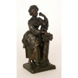 A bronze figure of a lady resting a basket of flowers on a tree stump on a square base,