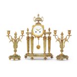 An early 20th Century French onyx and gilt metal clock garniture of pillared form,