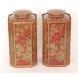 A pair of contemporary toleware tea canisters of octagonal form decorated with Chinoiserie imagery