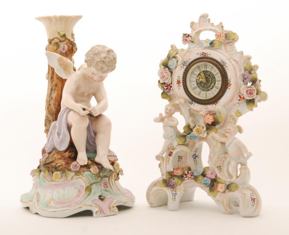 A late 19th Century Continental candlestick formed as a cupid fixing his bow with a quiver of